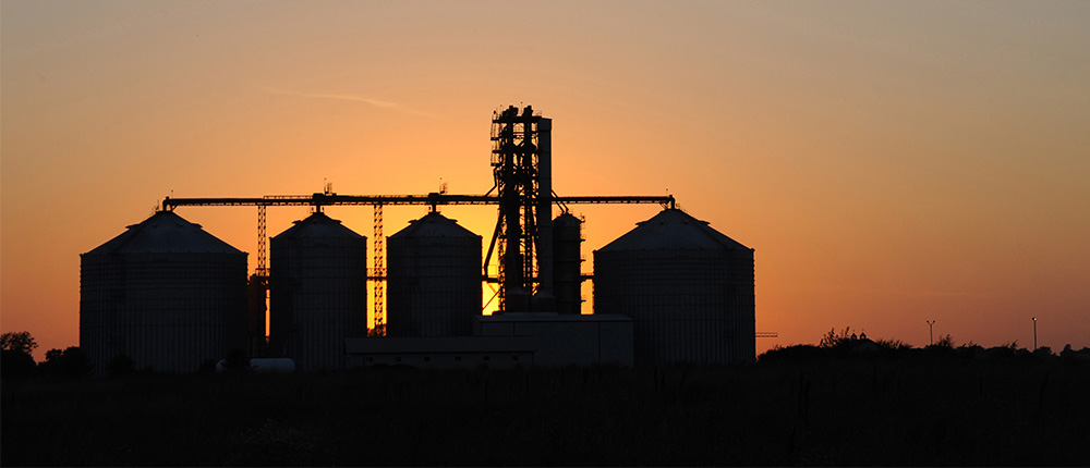 Silhouette of a grain elevator at sunset