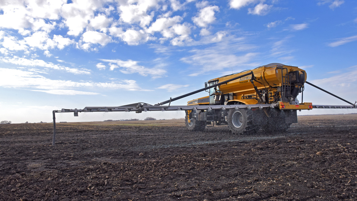 Machinery spreading fertilizer